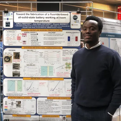 Standing next to the LRCS scientific poster on fluoride-ion battery research